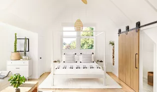 White on white bedroom with dramatic slider door